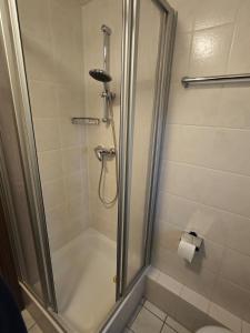 a bathroom with a shower with a glass door at Watt'n Wunder in Cuxhaven