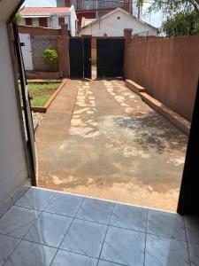 an open door to a patio with a fence at Soa Land villa in Antananarivo