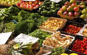 a display of fruits and vegetables at a market at cozy House with Secret Garden & Spa private in Fortuna