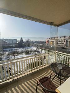 a balcony with a table and chairs and a view at Verde apartments in Sarajevo