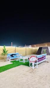 un grupo de bancos sentados en la playa en Big bear camping, en Nafīr