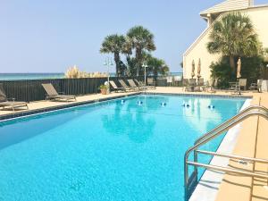 a large swimming pool with blue water in a resort at The Shores Townhome #116 in Carillon Beach