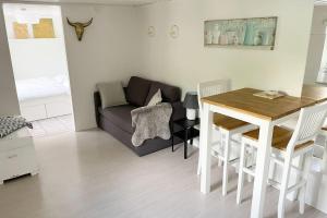 a living room with a couch and a table at Dennis beachhouse in Trelleborg