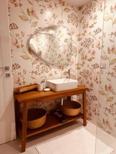 a bathroom with a sink and a mirror on a wall at Casina Ada & Niní in Galatina