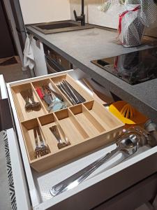 a drawer in a kitchen with a bunch of utensils at Sodi Cozy apartment in Karditsa