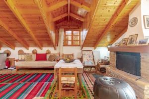 a living room with a couch and a fireplace at Stone Mountainhouse near Kalavryta, North Peloponnese, Greece in Dhoumená
