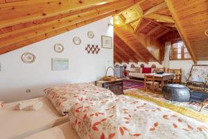 a bedroom with a large bed in a room with wooden ceilings at Stone Mountainhouse near Kalavryta, North Peloponnese, Greece in Dhoumená