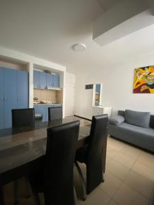 a living room with a table and chairs and a couch at Vila Marina Divčibare in Divčibare