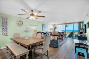 a dining room and living room with a table and chairs at Shoreline Towers 2025 in Destin