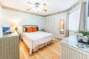 a bedroom with a bed and a ceiling fan at Island Sands 206 in Fort Walton Beach