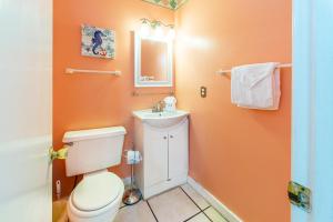 a bathroom with a toilet and a sink at Island Sands 206 in Fort Walton Beach +18 photos