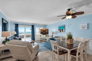 a living room with a table and a dining room at Holiday Surf and Racquet Club 319 in Destin
