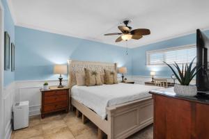 a bedroom with a bed and a ceiling fan at Holiday Surf and Racquet Club 319 in Destin +28 photos