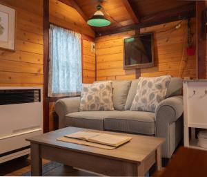 a living room with a couch and a coffee table at Hillside Bungalows in Banff