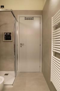 a glass shower door in a bathroom with a sink at Stelle di Verona - Andromeda in Verona +35 photos