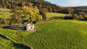 an aerial view of a small house in a field at La Cabane LeLa in Theux +4 photos