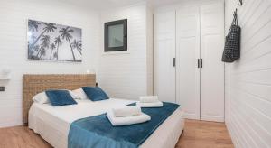 a bedroom with a bed with two towels on it at Parrot’s House in Lloret de Mar