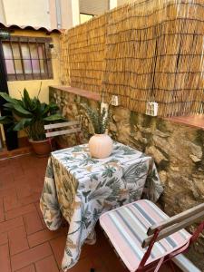 a table and chairs with a vase on a patio at Tarraco Cathedral Cottage in Tarragona
