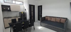 a kitchen with a couch and chairs in a room at Villa luna in Carmen de Apicalá
