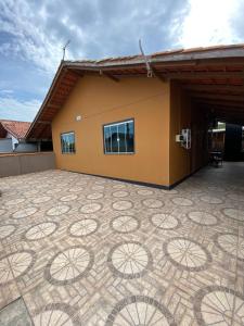a building with a tiled floor in front of it at JOÃO CARLOS CASAS 3 Quartos Penha SC in Penha