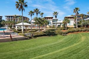 a view of a resort with palm trees at Comfort and Joy in Seacrest
