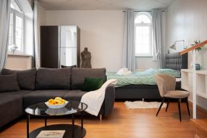 a living room with a couch and a bed at Studio Magnolia in Velika Gorica