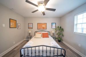 a bedroom with a bed with a ceiling fan at OV Mosaic - Float Suite in North Camellia Acres