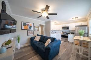 a living room with a blue couch and a kitchen at OV Mosaic - Coconut Suite in North Camellia Acres