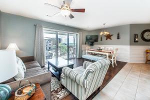a living room with a couch and a table at Beachside Villas 332 in Santa Rosa Beach