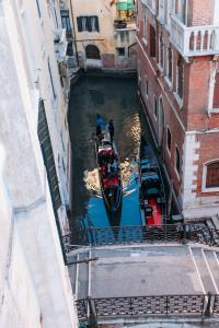 a boat in a canal between two buildings at Residenza Dei Dogi in Venice
