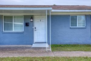 a blue brick house with a white door at Southern Charm 3-0 in Columbus