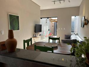 a living room with a table and a couch at Casa Villa Bali in Marechal Deodoro