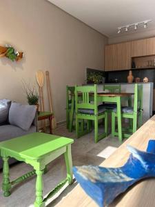 a living room with green tables and a couch at Casa Villa Bali in Marechal Deodoro