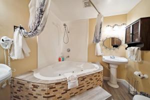 a bathroom with a large tub and a sink at Coastal Pet Friendly Gem Near the Beach and Shopping in Newport Beach +39 photos
