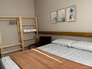 a bedroom with a bed and a shelf at Casa Villa Bali in Marechal Deodoro