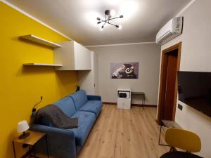 a living room with a blue couch and yellow walls at Ca'Lupetta - Laghi e Natura in Varallo Pombia +86 photos