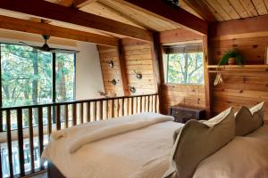 a bedroom with a large bed in a cabin at Treehouse - Close to Slopes, Hot Tub, Gourmet Kitchen, Deck in Big Bear Lake