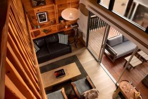 an overhead view of a living room with a couch and chairs at Treehouse - Close to Slopes, Hot Tub, Gourmet Kitchen, Deck in Big Bear Lake