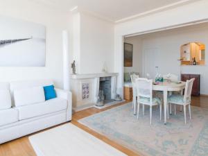 a living room with a white couch and a table at Studio in Ostend with Stunning Sea Views in Ostend