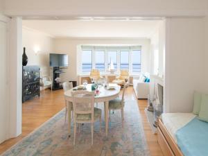a dining room and living room with a table and chairs at Studio in Ostend with Stunning Sea Views in Ostend