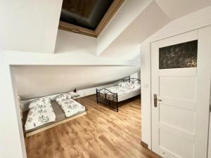 a room with two beds and a door at Mountain View Apartament Termy Chochołowskie 5 min in Suchá Hora +95 photos