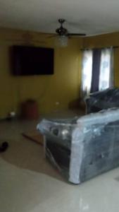 a living room with a couch and a ceiling at Dunbar's Two bedroom in Montego Bay +3 photos