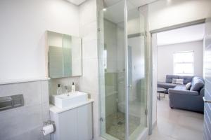 a bathroom with a sink and a glass shower at Apartment 73 - 1 On York in George +5 photos