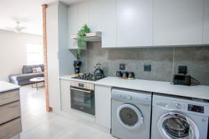 a kitchen with a washer and dryer in it at Apartment 73 - 1 On York in George