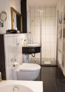 a bathroom with a toilet and a sink at Historik Hotel Goldener Hirsch Rothenburg in Rothenburg ob der Tauber