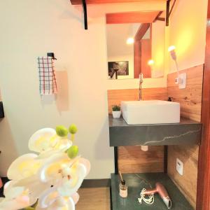 a bathroom with a sink and a mirror at Perfeito Studio 21 in Poços de Caldas
