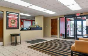 a lobby with a waiting room with a desk and chairs at Extended Stay America Suites - Detroit - Madison Heights in Madison Heights