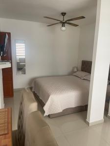 a bedroom with a bed and a ceiling fan at Italia boutique #3 in Barranquilla