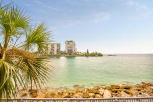 a large body of water with buildings and palm trees at Land's End 5-204 Gulf-Bay Front - Premier in St. Pete Beach