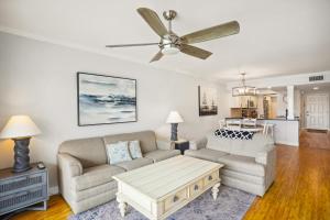 a living room with a couch and a ceiling fan at Land's End 5-204 Gulf-Bay Front - Premier in St. Pete Beach